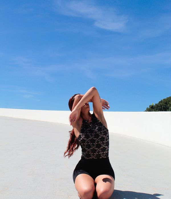 Woman feeling serene and energetic in a bright, open space.